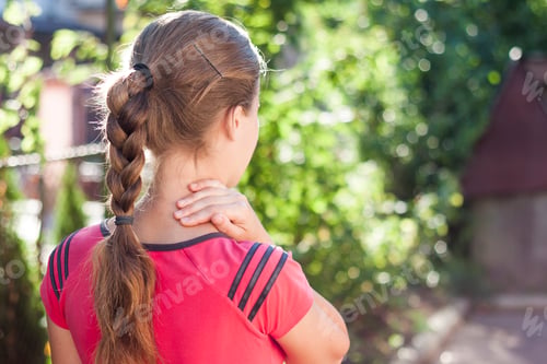 Preview: Young woman with a braid on sunny day
