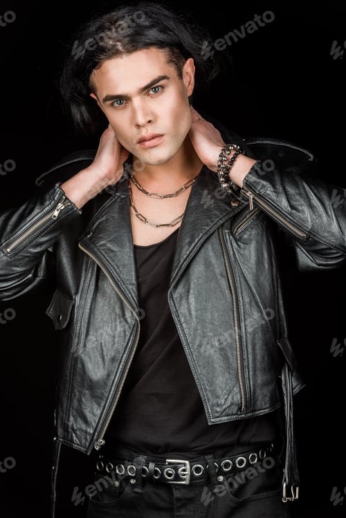 Preview: handsome man in leather jacket touching neck and looking at camera isolated on black