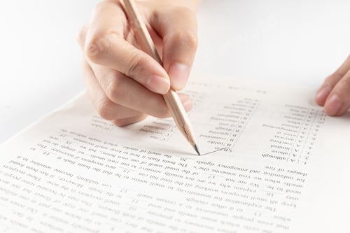 Preview: Hand of businesswoman writing on paper in the office