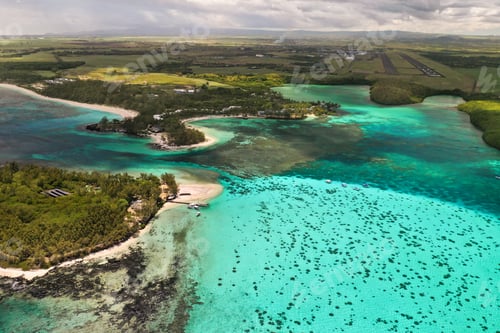 Preview: Top view of the Blue Bay lagoon of Mauritius. A boat floats on a turquoise lagoon
