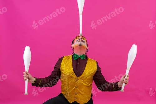 Preview: Cheerful circus performer skillfully juggling a number of clubs isolated on pink background