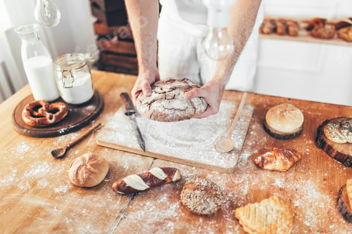 Preview: Baker with a variety of delicious freshly baked bread and pastry