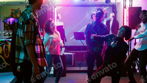 Preview: Cheerful adults dancing at disco party