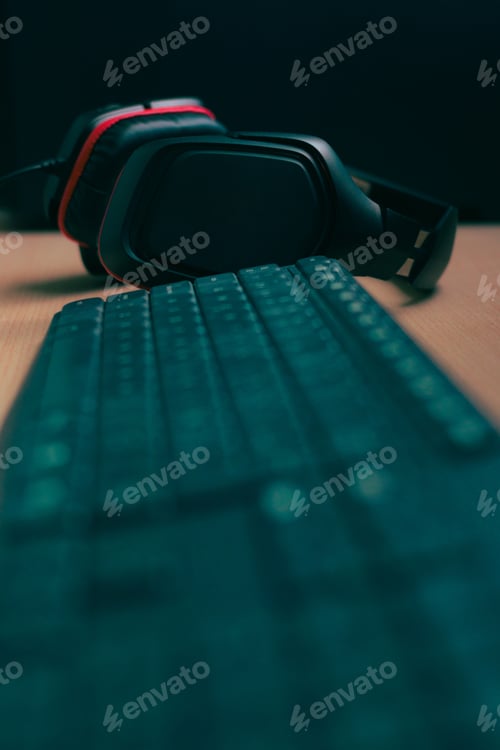 Preview: Music headphones and a computer keyboard on a desk