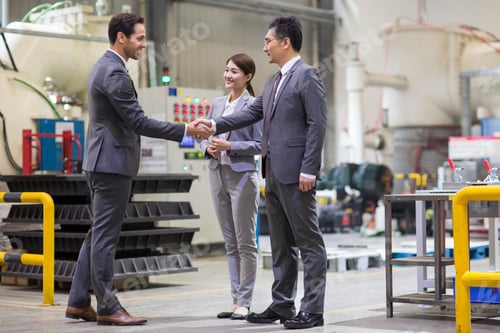 Preview: Business people shaking hands in the factory