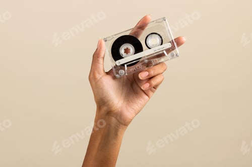 Preview: Black female hand showing plain cassette tape
