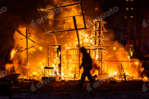 Preview: Firefighter with his protective suit working controlling the burning of a Falla