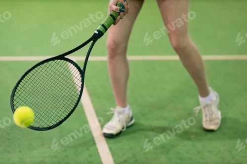 Preview: Tennis woman player playing training with racket and ball at court