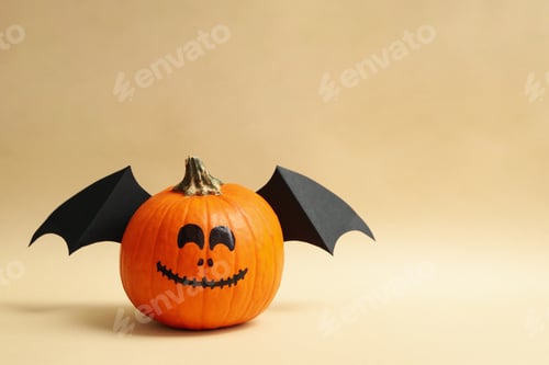 Preview: Pumpkins with smile and wings on beige background