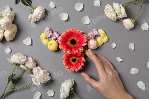 Preview: Uterus, flowers and female hand on gray background, top view