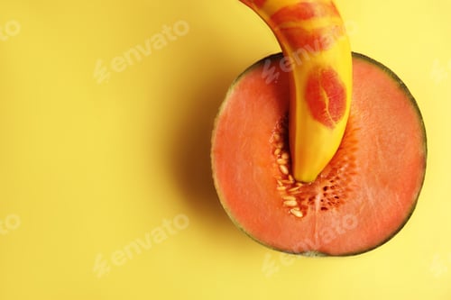 Preview: Flat lay composition with fresh banana and melon on yellow background, space for text. Sex concept