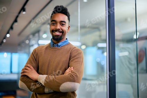 Preview: Confident black businessman in the office looking at camera.