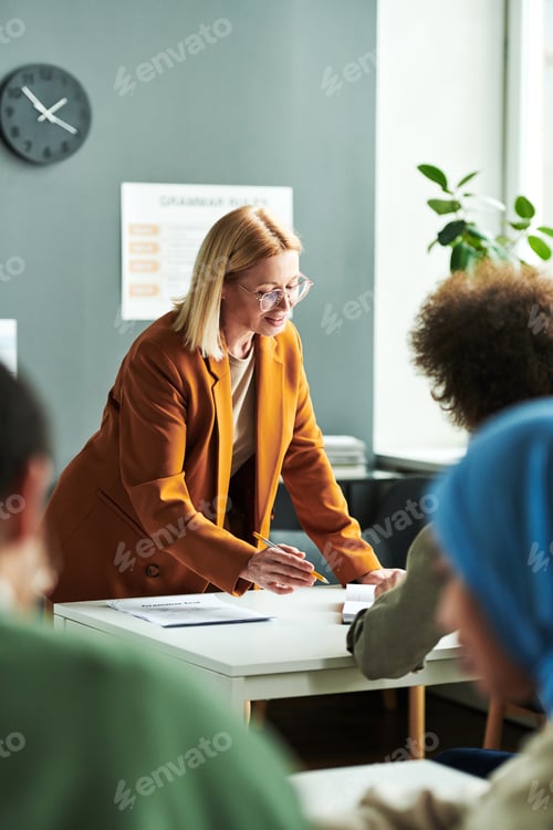 Visualização: Professora madura loira confiante explicando algo para o aluno