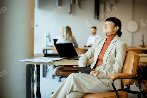 Preview: Professional woman enjoying a moment of peace in a modern office space