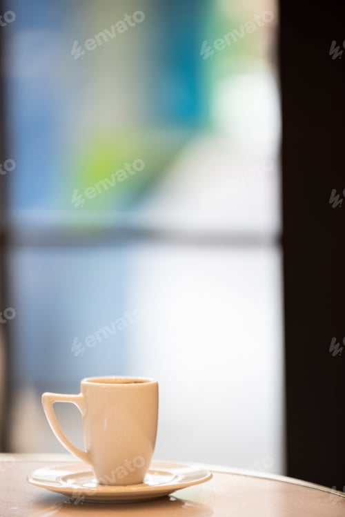 Preview: Cup of coffee on a round table, vertical.