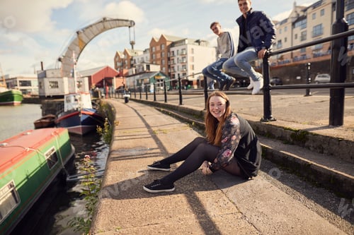 Preview: Portrait of three friends sitting beside river, Bristol, UK