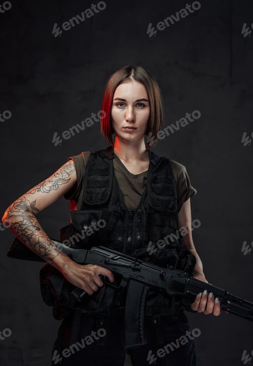 Preview: Tattoed martial woman in black armour with assault rifle