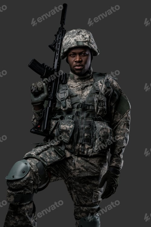 Preview: Courageous black soldier dressed in uniform and holding rifle