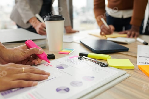 Preview: Businesswoman Highlighting Data in Report