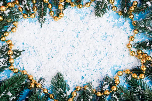 Preview: Flat lay with necklace, pine branches and artificial snow on blue background