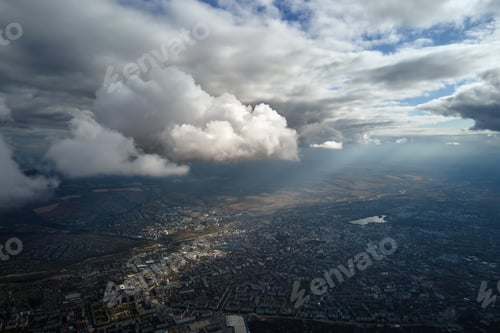 Preview: Aerial view from airplane window at high altitude of distant city