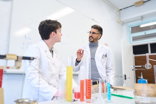 Preview: Chemistry teacher explaining experiment to student in laboratory