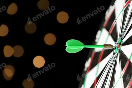 Preview: Green arrow hitting target on dart board against blurred lights. Space for text