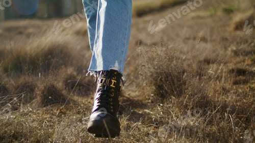 Preview: Woman legs going meadow closeup. Unrecognizable lady walking in autumn nature