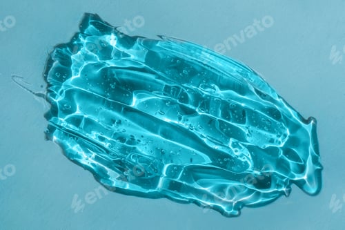 Preview: Squeezed cosmetic gel blob smudge on blue shadow background. Styling gel swatch, lotion smear, aloe