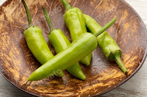 Preview: Bowl with whole fresh raw green rawit peppers close up