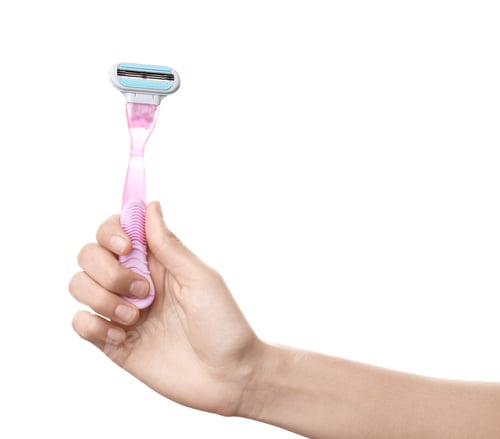 Preview: Woman holding razor on white background, closeup