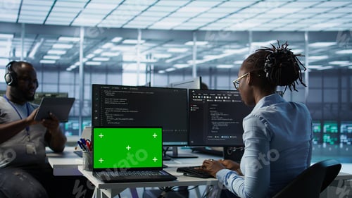Preview: Team of developers in server hub using green screen laptop