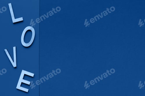 Preview: The word love consists of wooden letters located on a blue background with space for text