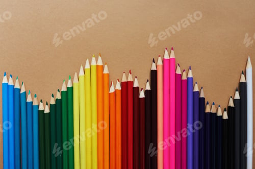 Preview: Studio shot of different coloured pencils against a brown background