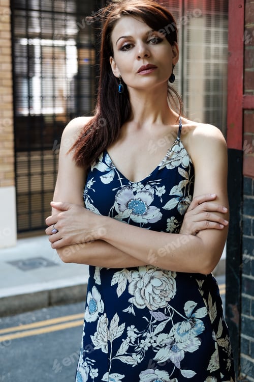 Preview: Beautiful mature woman posing in the street.
