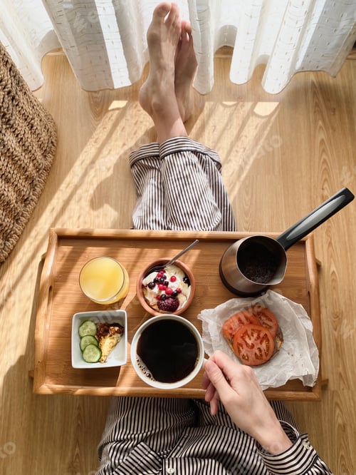 Preview: Woman having brunch/breakfast at the floor , coffee, greek yogurt with berries