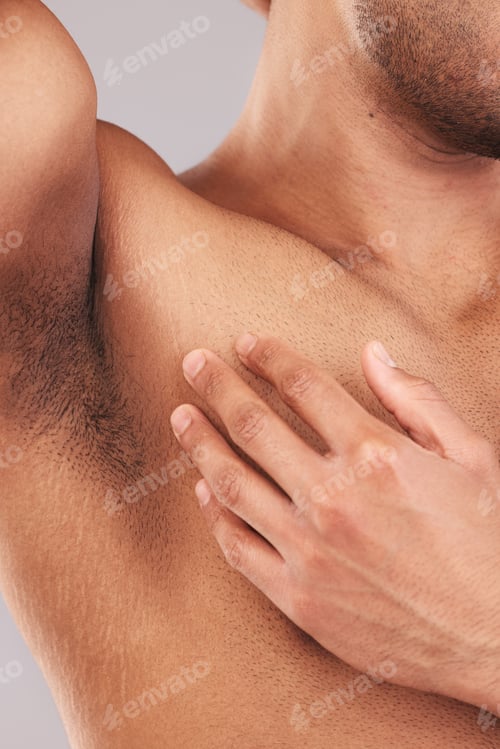 Preview: Armpit, clean and hand of man touching skin for health, wellness and beauty at a spa against a stud