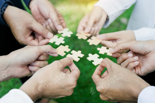 Preview: group of business people assembling jigsaw puzzle. The concept of cooperation
