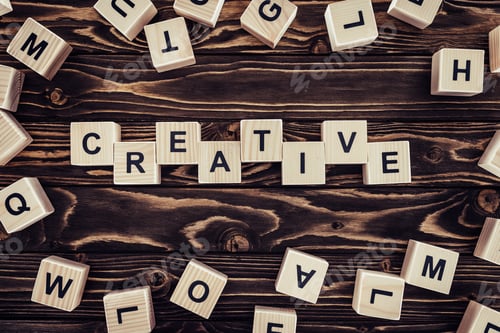 Preview: flat lay with blocks arranged in creative word on brown wooden surface