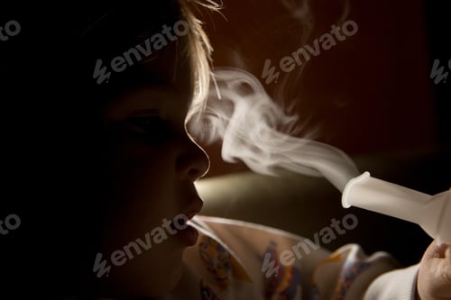 Preview: Boy inhaling with inhaler