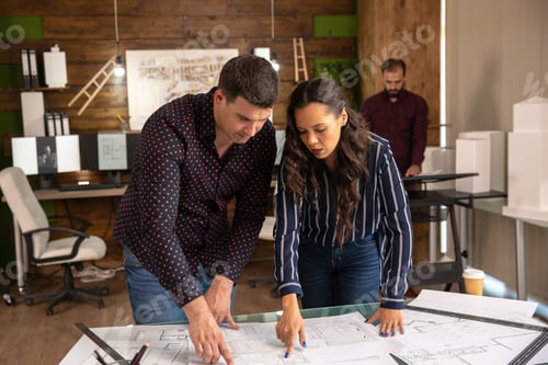 Preview: Two architects doing brainstorming in the office