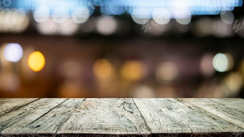 Preview: Empty wooden table bokeh lights backdrop.