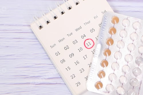 Preview: birth control pills , calendar and notepad on table