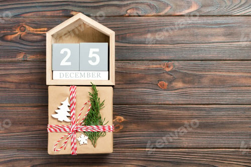 Preview: Calendar with date 25 december and gift boxes on color background.
