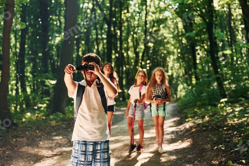 Preview: Beautiful nature. Kids strolling in the forest with travel equipment