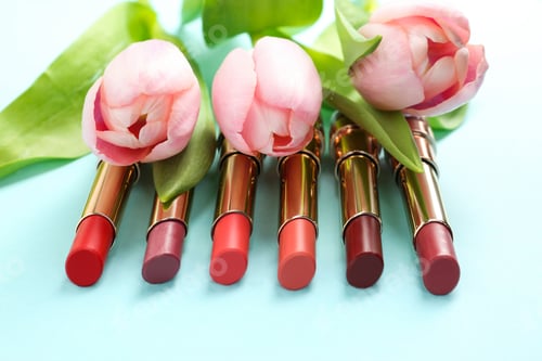 Preview: Bright lipsticks and spring flowers on light blue background