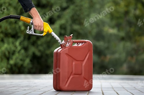 Preview: Man's hand holding a filling gun over a canister