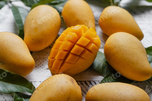 Preview: Ripe mangoes on white wood