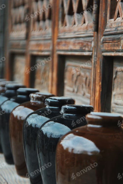 Preview: Vertical closeup of ceramic wine jars arranged in a row in Gubei water town, China