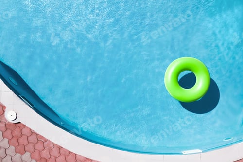 Preview: Inflatable ring floating in swimming pool, top view with space for text. Summer vacation
